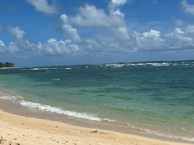 Calm turquoise water with kayaker