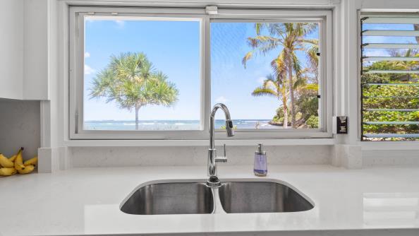 Bright white kitchen with ocean view